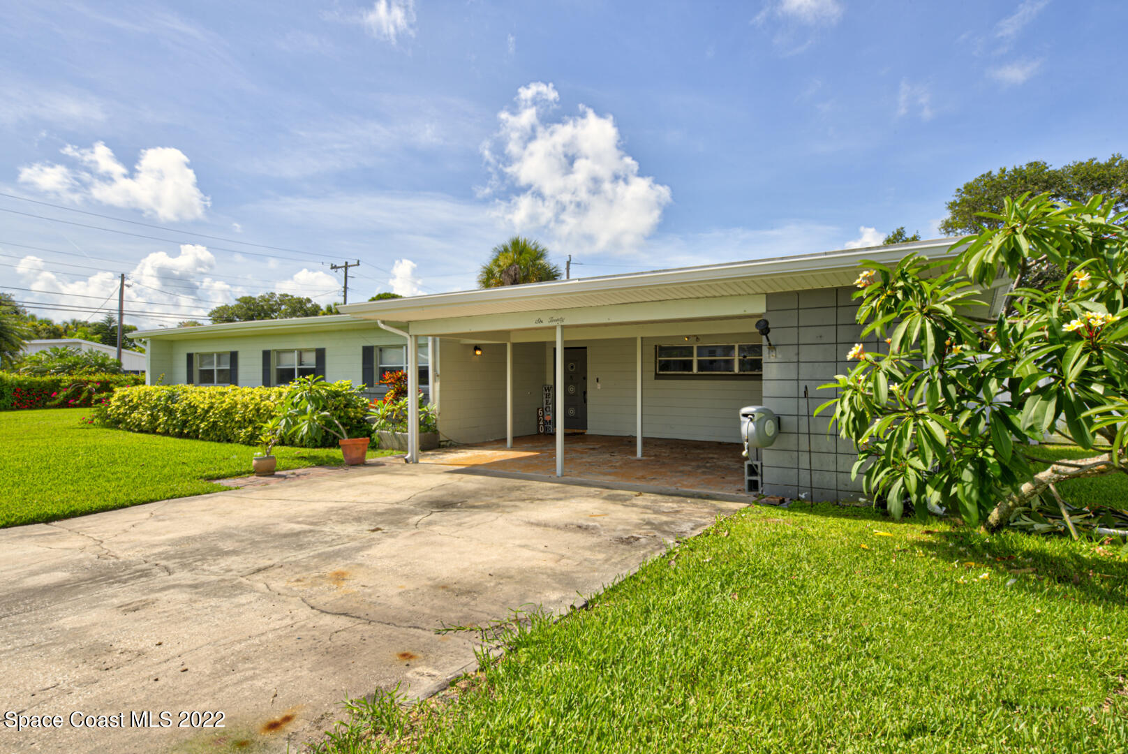 620 Java Road Cocoa Beach, FL 32931 - Photo 3 of 39 a front view of a house with a garden and plants