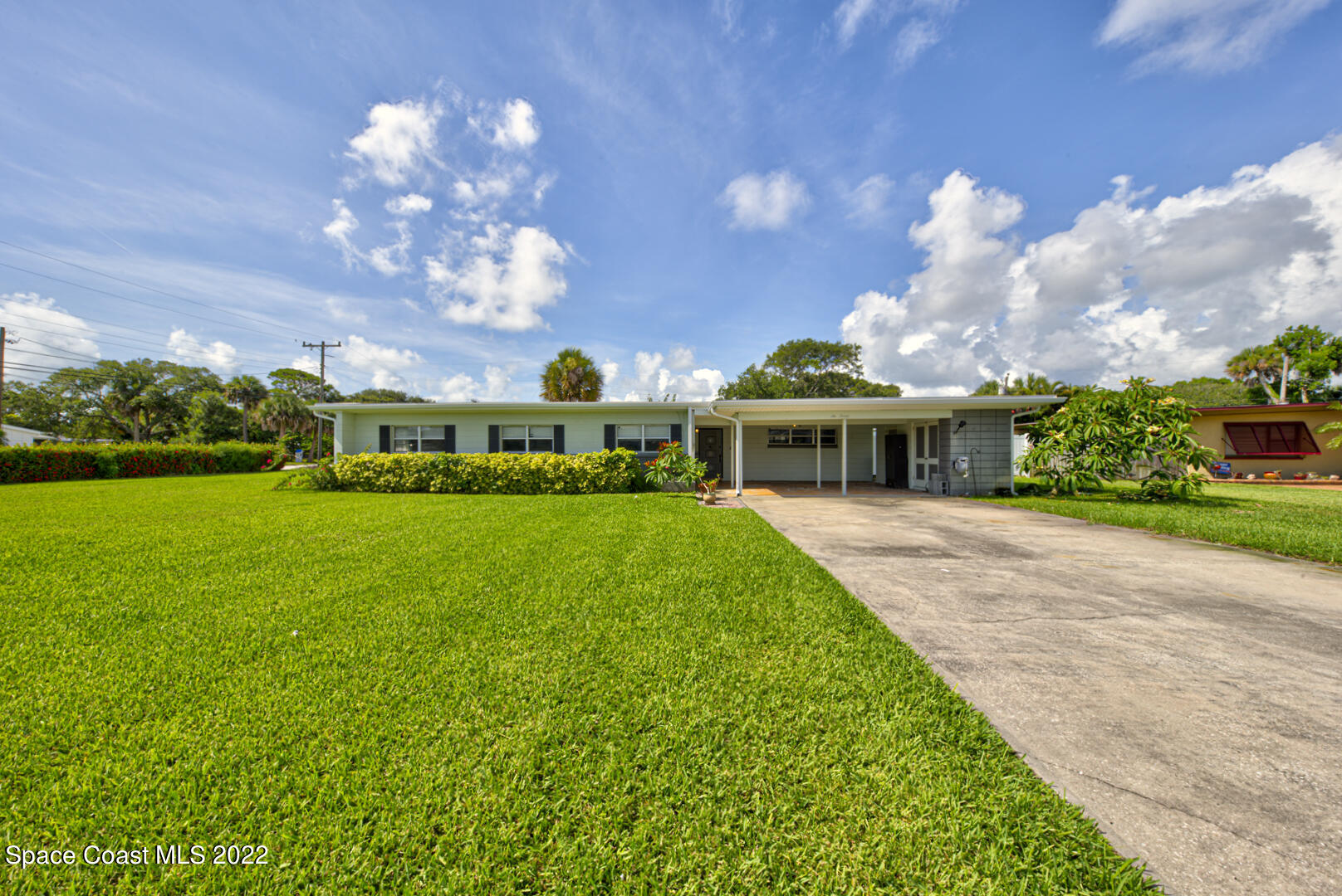 620 Java Road Cocoa Beach, FL 32931 - Photo 39 of 39 a front view of a house with garden and a yard