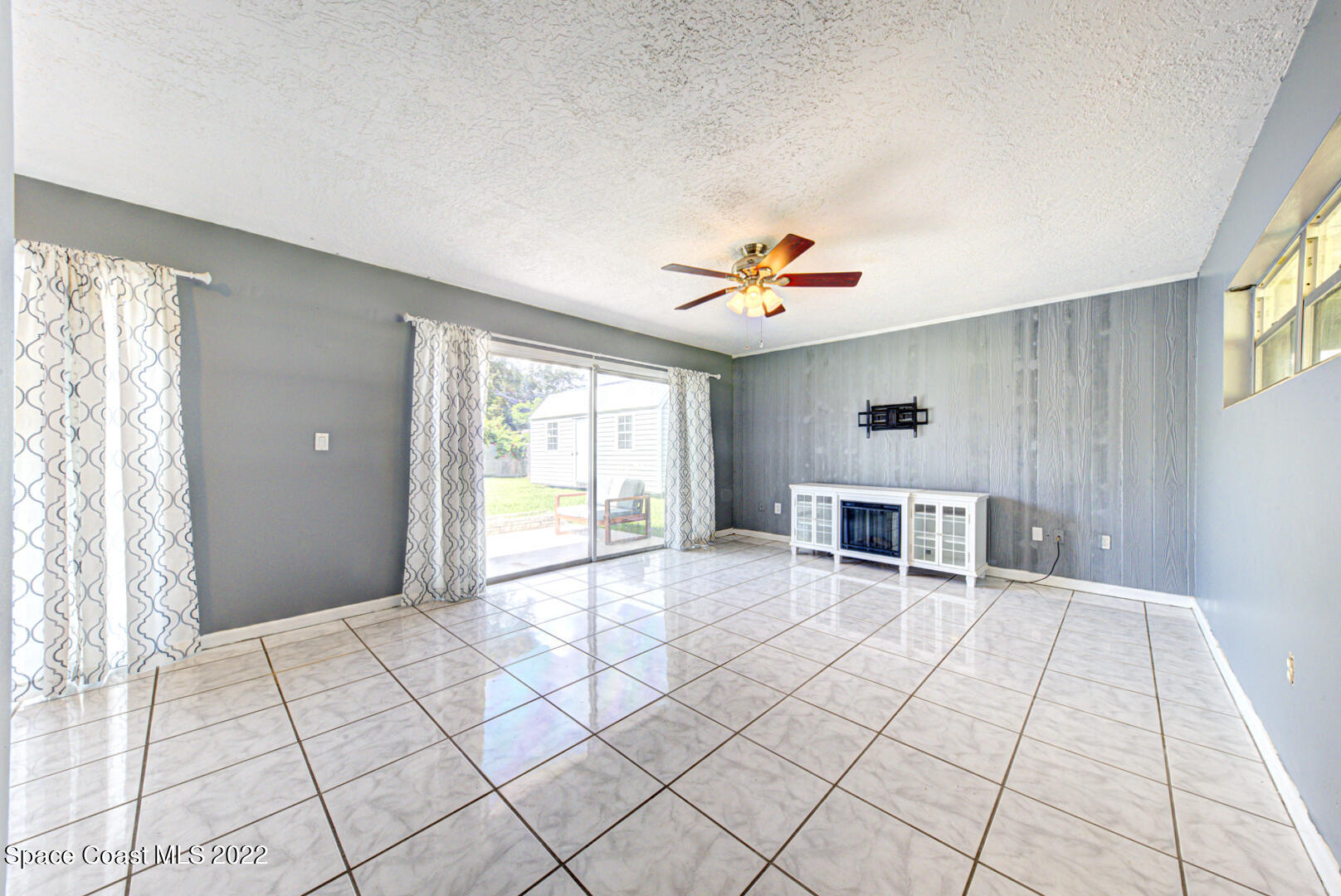 620 Java Road Cocoa Beach, FL 32931 - Photo 8 of 39 a view of an empty room with window and cabinet