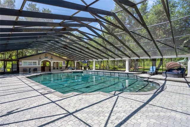 a view of a swimming pool with red chairs