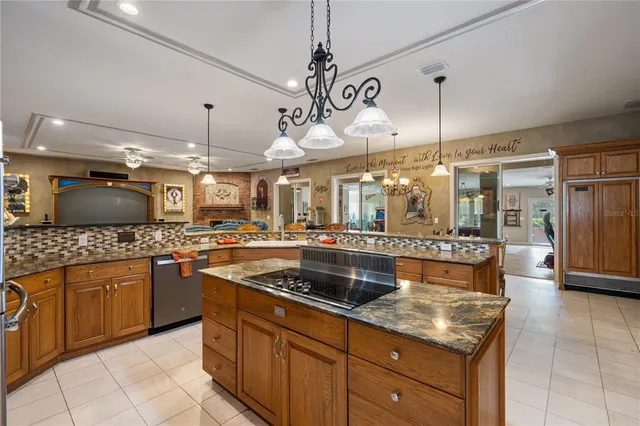 a kitchen with stainless steel appliances granite countertop a sink and a stove