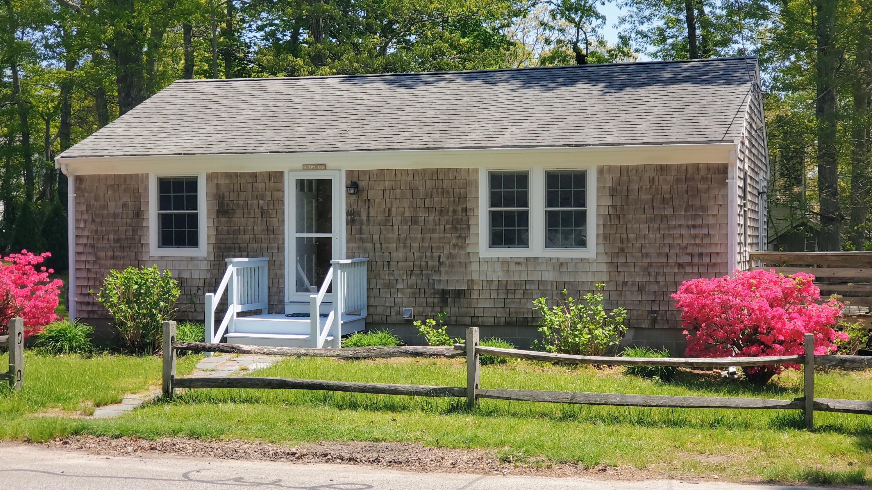 66 Uncle Edwards Road Mashpee, MA 02649 - Photo 2 of 18 a front view of a house with a yard