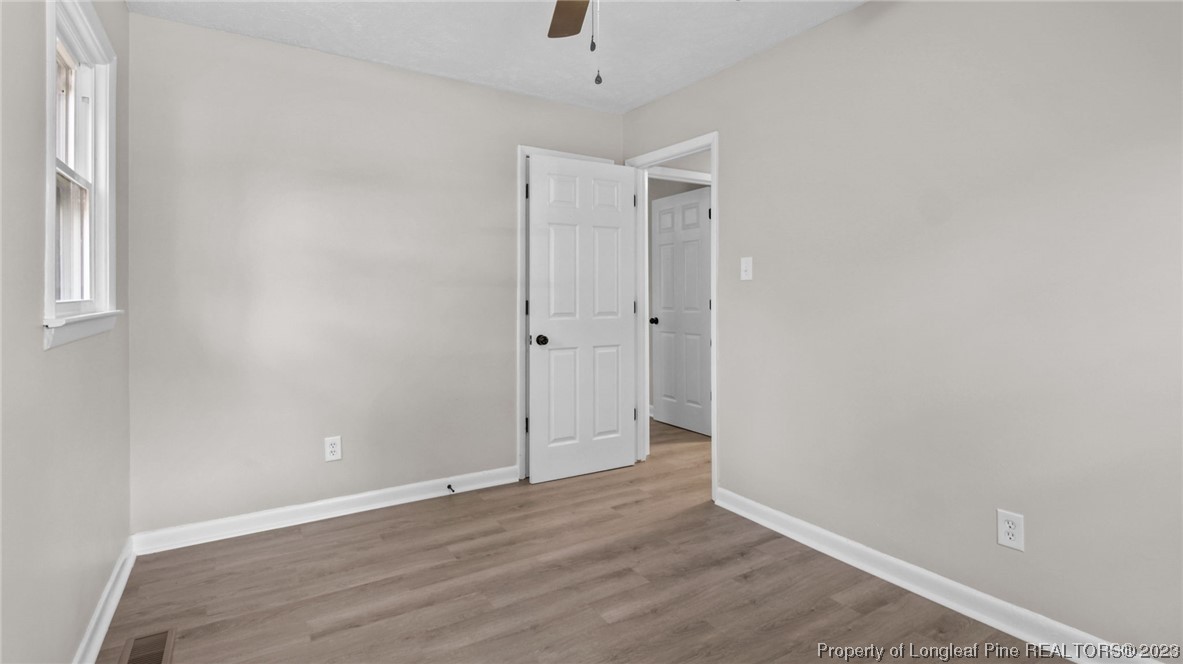 3610 Yorktown Road Hope Mills, NC 28348 - Photo 18 of 22 a view of an empty room with wooden floor and a window