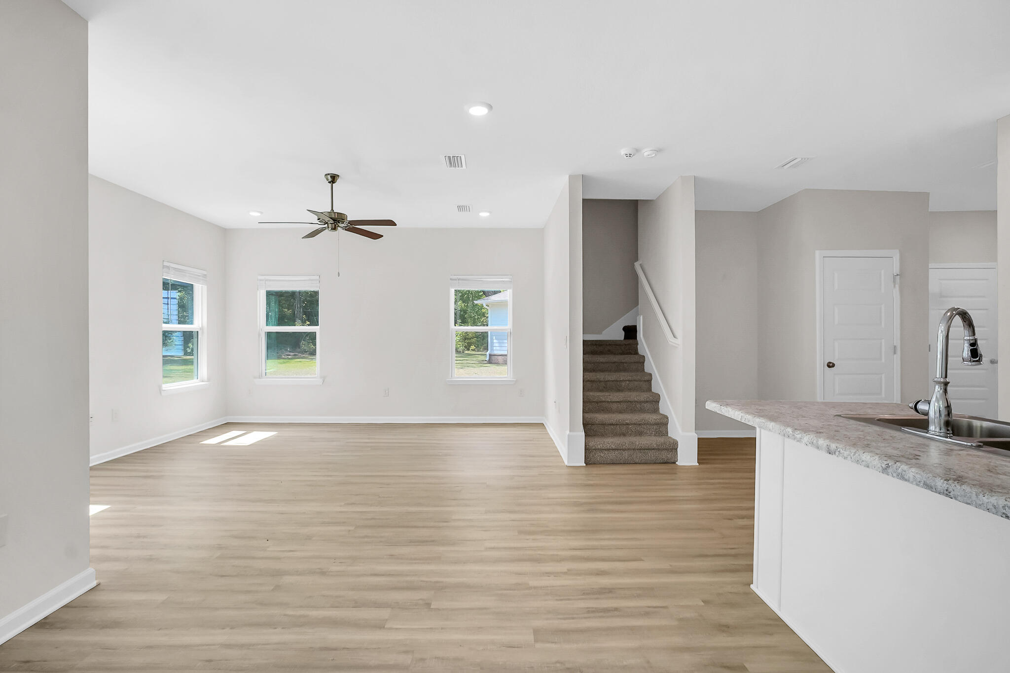 34 Sandywoods Court Freeport, FL 32439 - Photo 14 of 41 a view of a livingroom with wooden floor and staircase