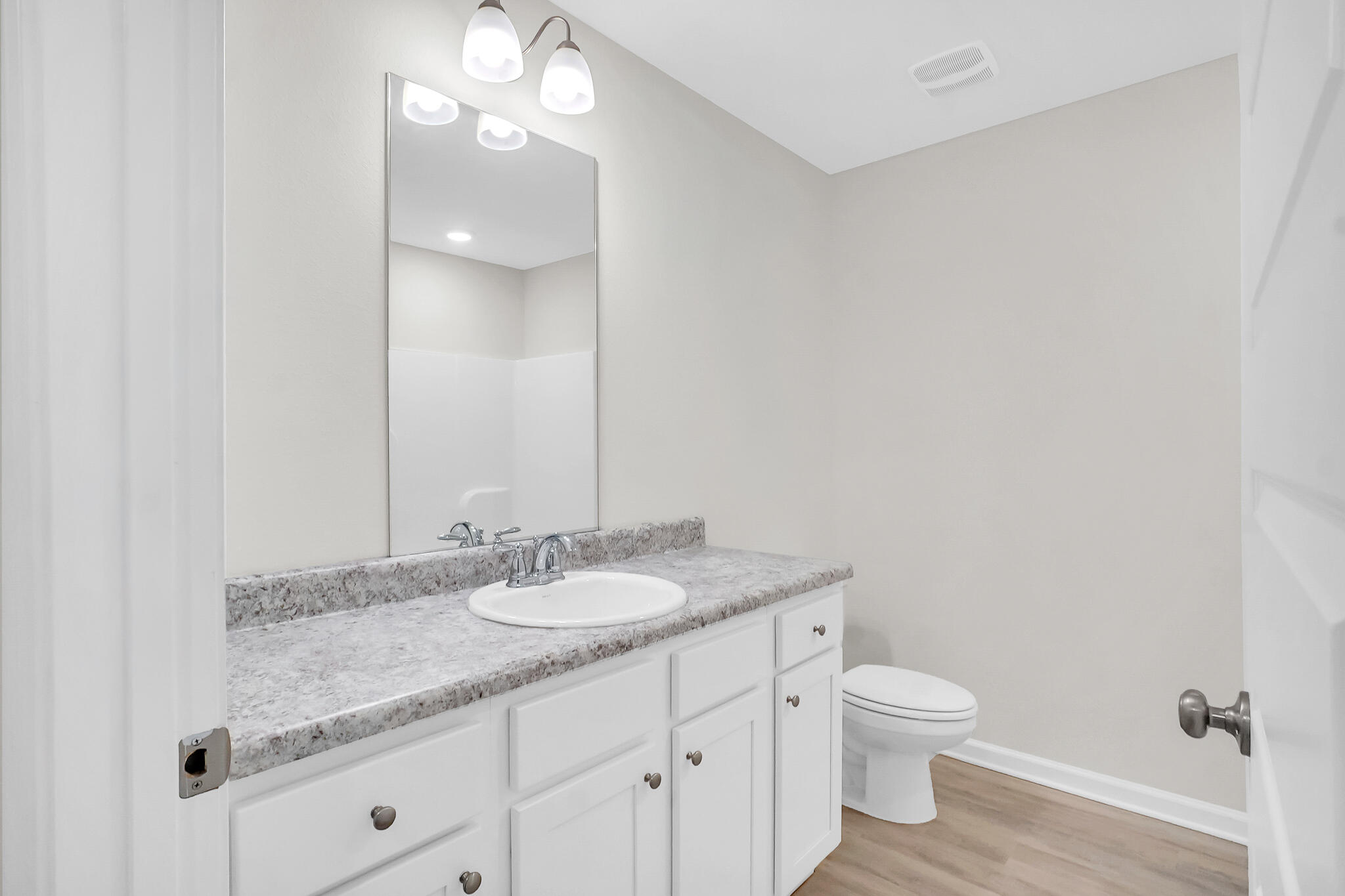 34 Sandywoods Court Freeport, FL 32439 - Photo 35 of 41 a bathroom with a granite countertop sink a toilet and a mirror