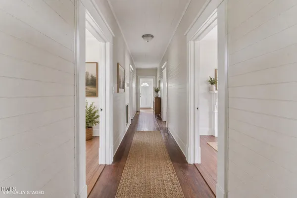 a view of a hallway with a wooden floor