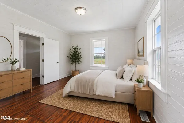 a bedroom with a bed and a dresser