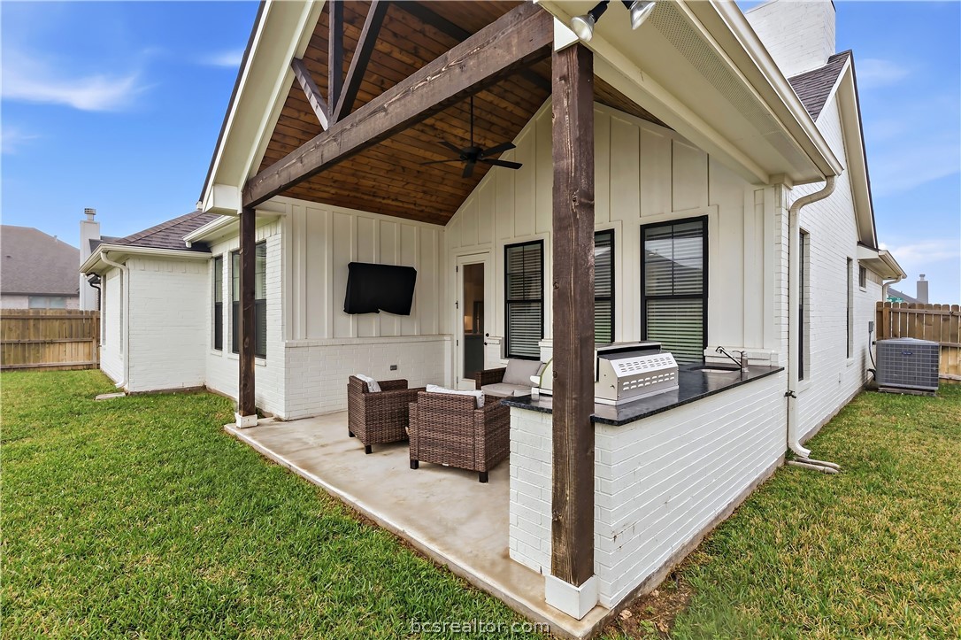 3512 Castine Court Bryan, TX 77808 - Photo 41 of 45 Lovely Covered patio with kitchen including grill, mini fridge, sink, tv & mount