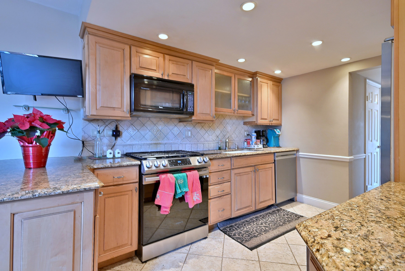 7 Birch Tree Court Elmhurst, IL 60126 - Photo 14 of 31 a kitchen with stainless steel appliances granite countertop a stove sink and cabinets