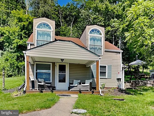a front view of a house with a garden and porch