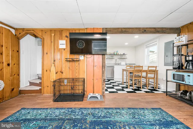 a view of a livingroom with workspace and a window