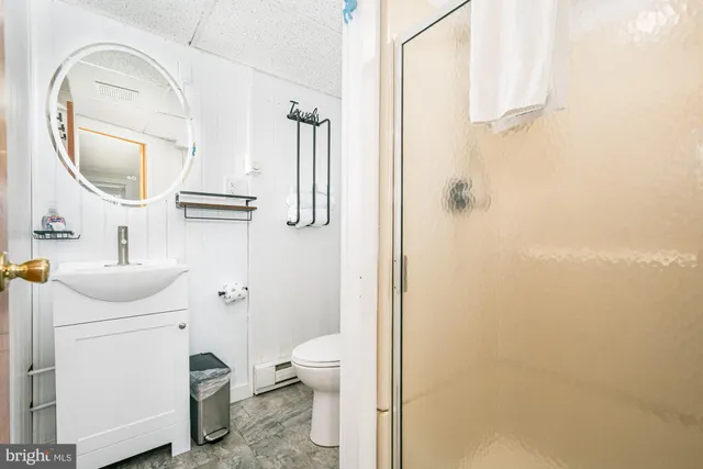 a bathroom with a sink toilet and a mirror