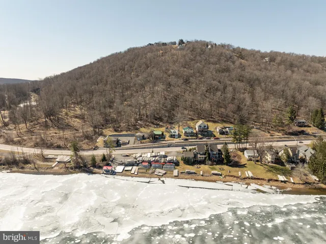 a view of a town with snow in the background