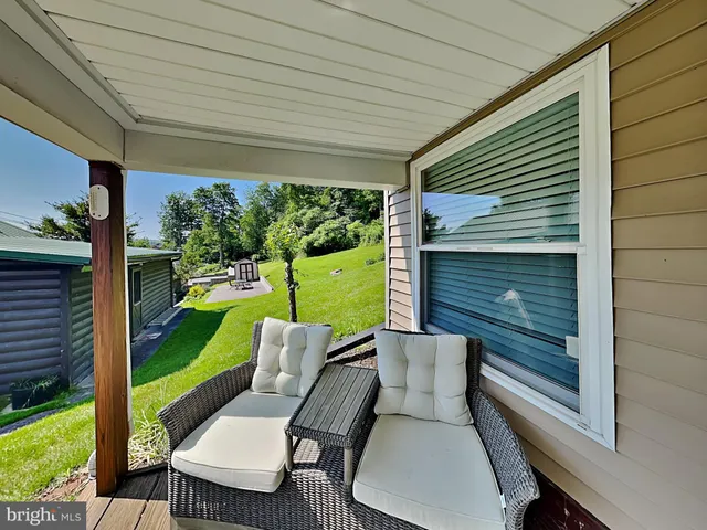 a view of a chair and tables in the patio