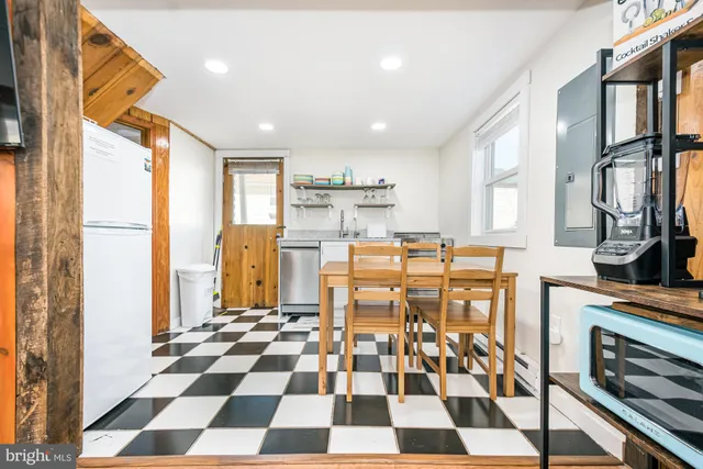 a kitchen with stainless steel appliances cabinets and a dining table