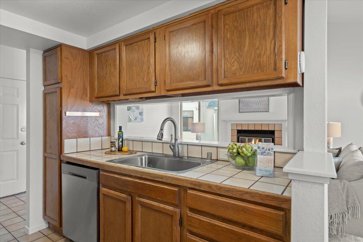 2392 North Main Street, Unit E Salinas, CA 93906 - Photo 12 of 27 a kitchen with stainless steel appliances granite countertop a sink and cabinets