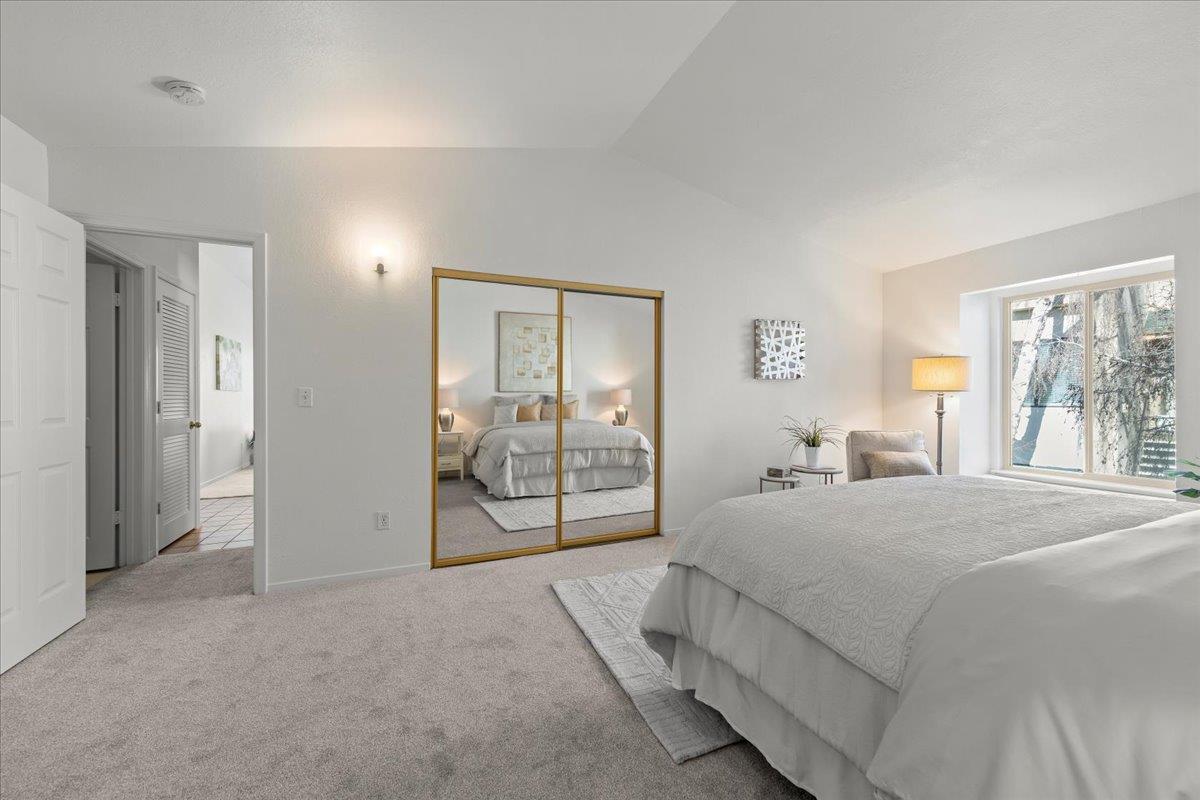 2392 North Main Street, Unit E Salinas, CA 93906 - Photo 17 of 27 a bedroom with a large bed and a chandelier