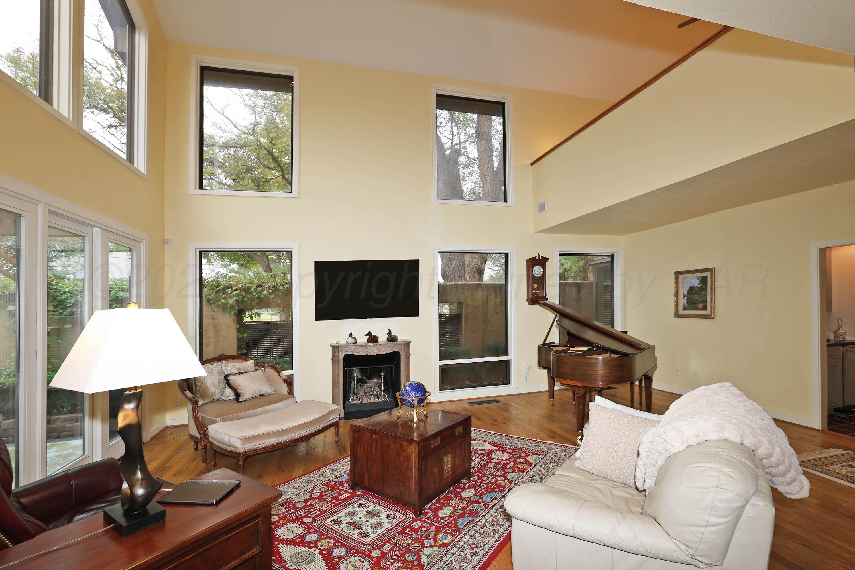 3 Woodstone Street Amarillo, TX 79106 - Photo 13 of 44 a living room with furniture a fireplace and a flat screen tv