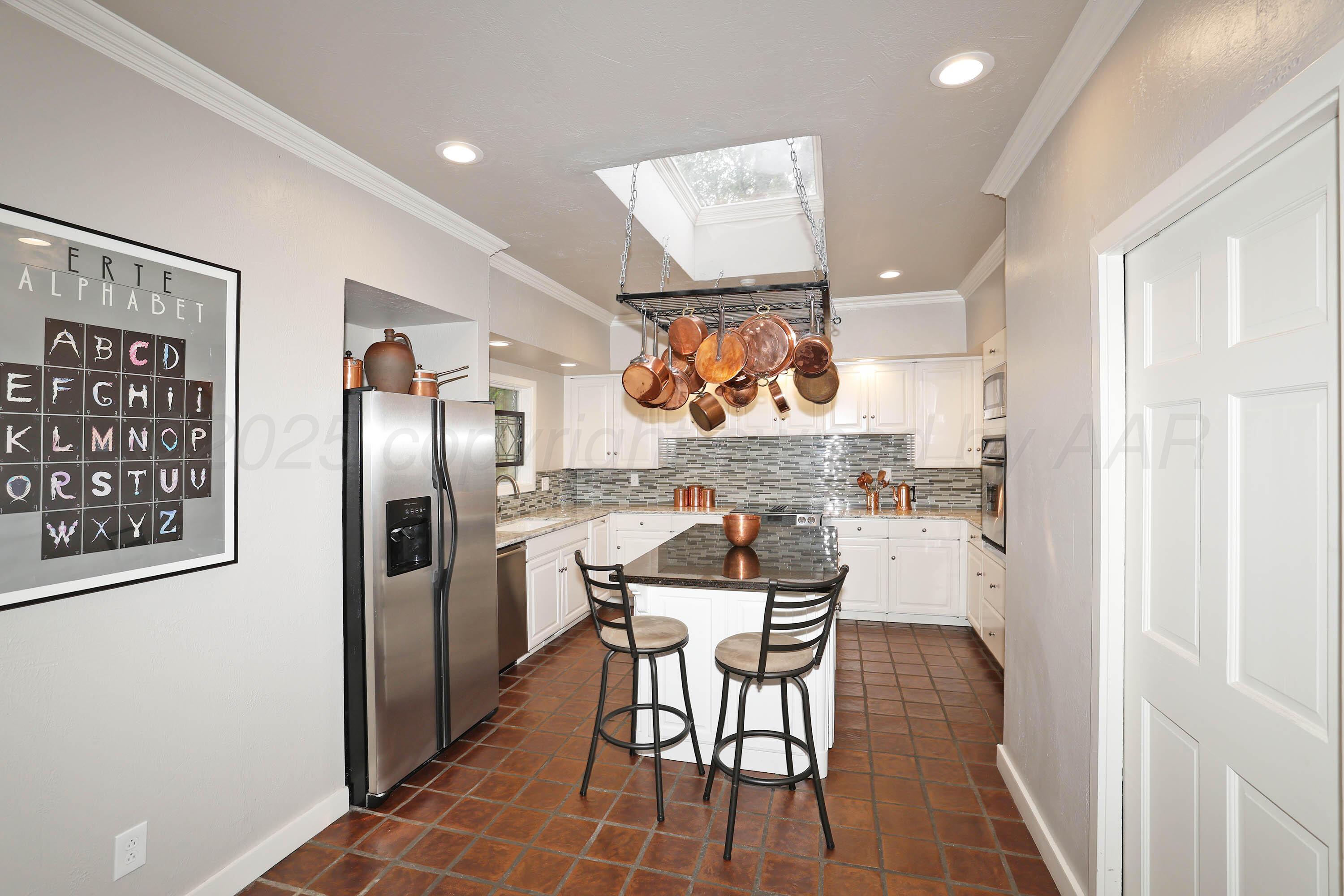 3 Woodstone Street Amarillo, TX 79106 - Photo 17 of 44 a kitchen with stainless steel appliances a refrigerator and a stove top oven