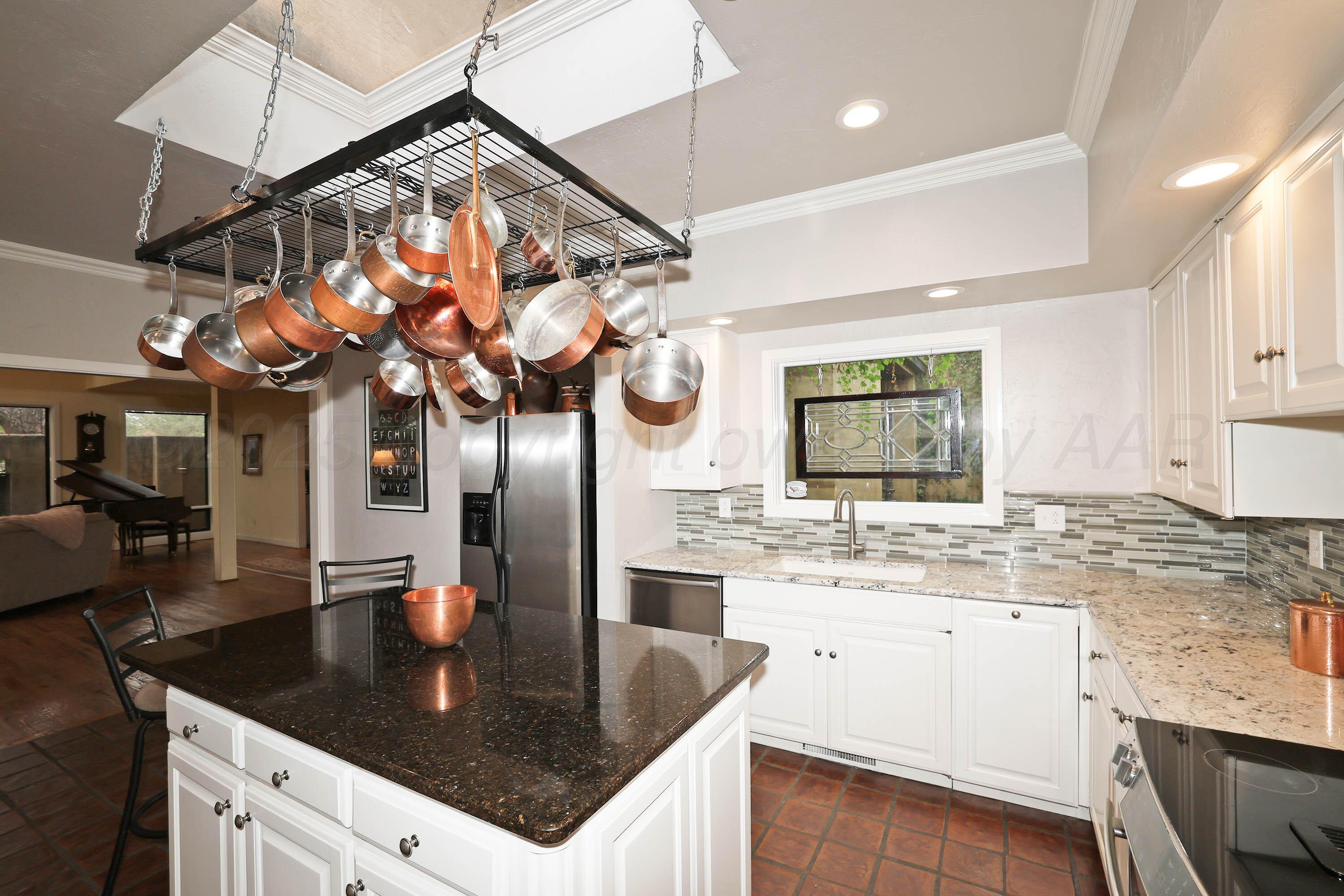 3 Woodstone Street Amarillo, TX 79106 - Photo 19 of 44 a kitchen with a sink a counter top space cabinets and stainless steel appliances