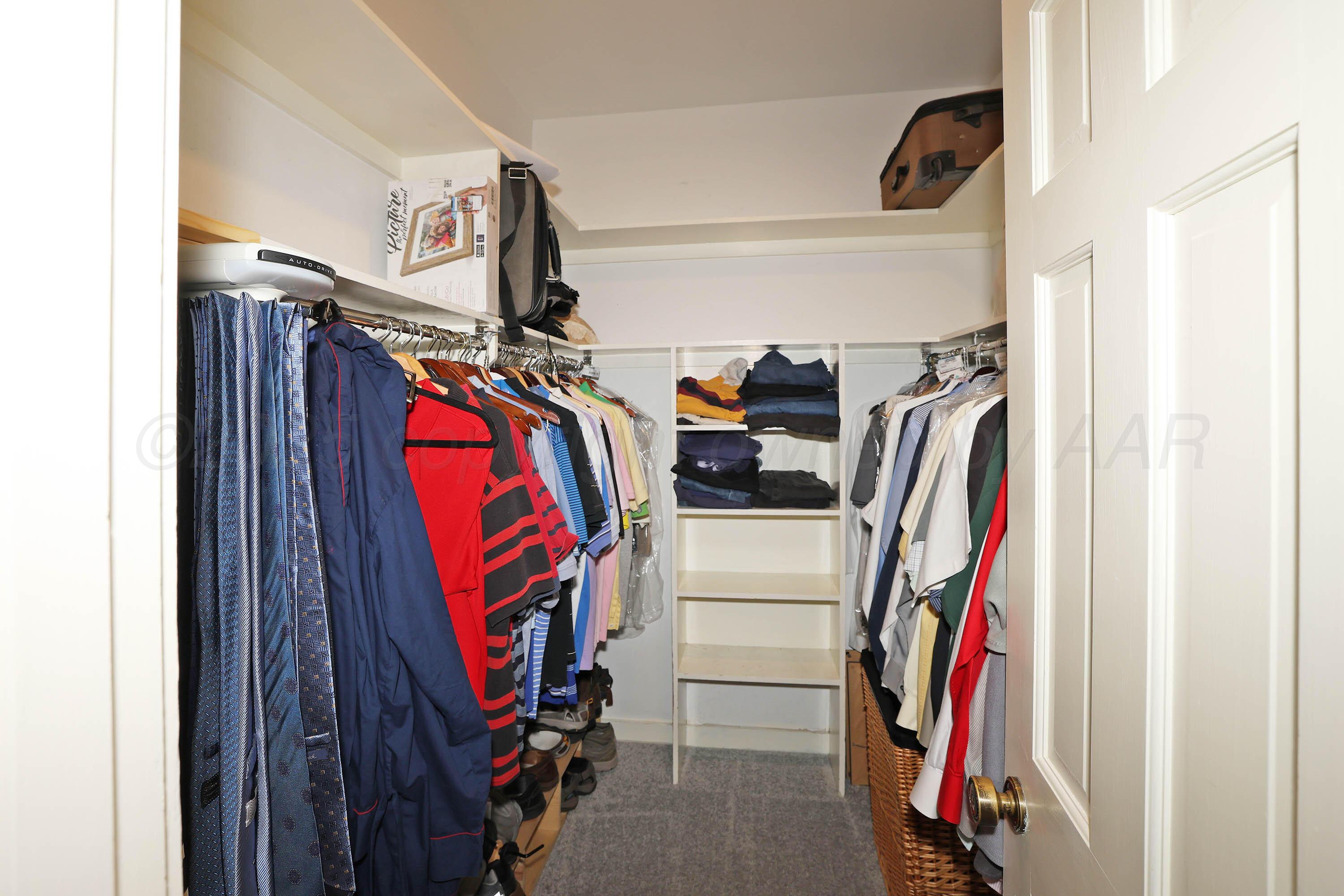 3 Woodstone Street Amarillo, TX 79106 - Photo 27 of 44 a view of walk in closet with clothes