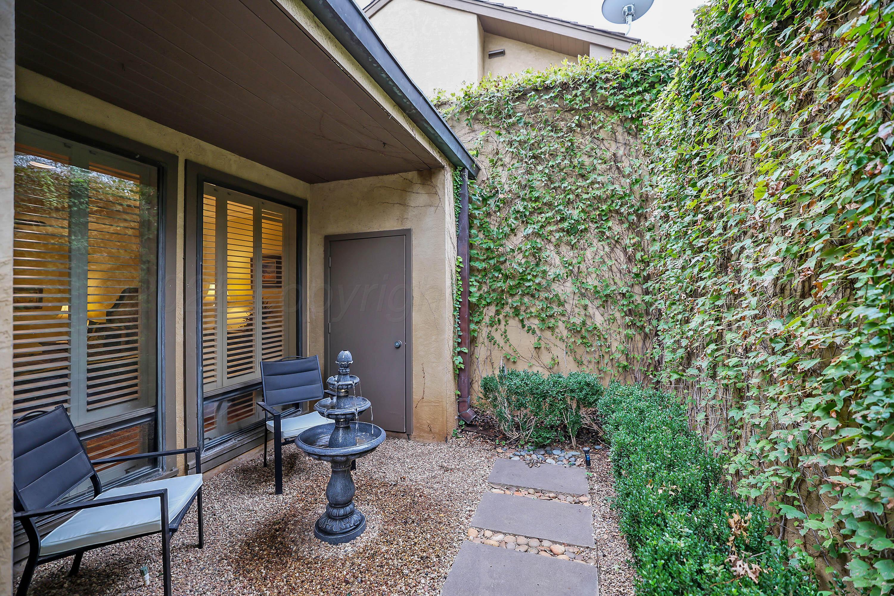 3 Woodstone Street Amarillo, TX 79106 - Photo 3 of 44 a view of a patio with table and chairs potted plants and large tree