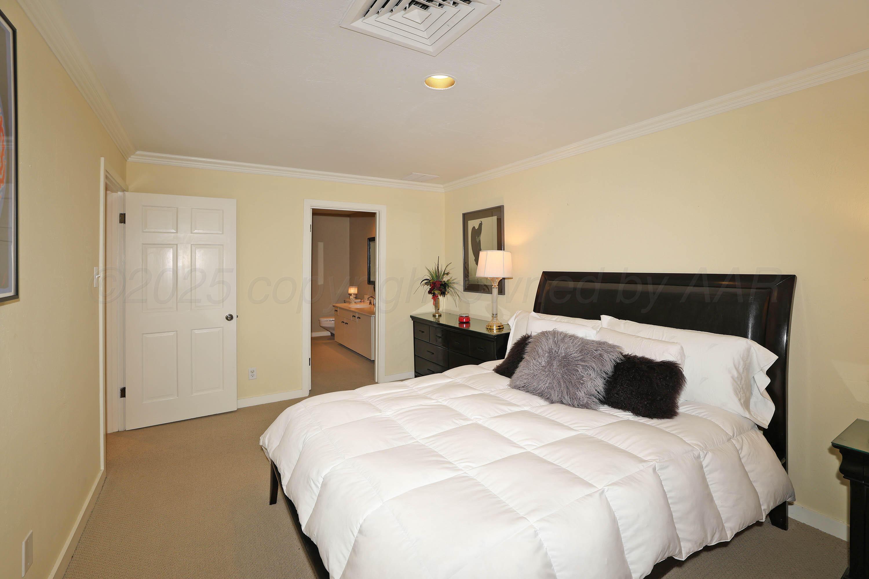 3 Woodstone Street Amarillo, TX 79106 - Photo 37 of 44 a bedroom with a bed and closet