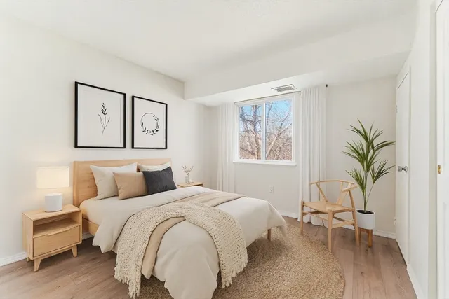 a bedroom with a large bed and a couch