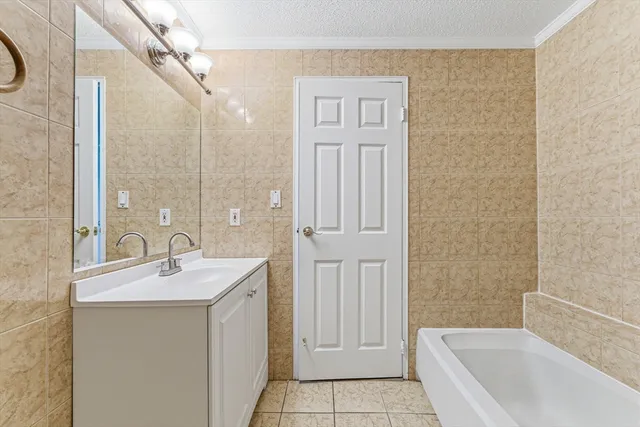 a bathroom with a sink a mirror and a bathtub