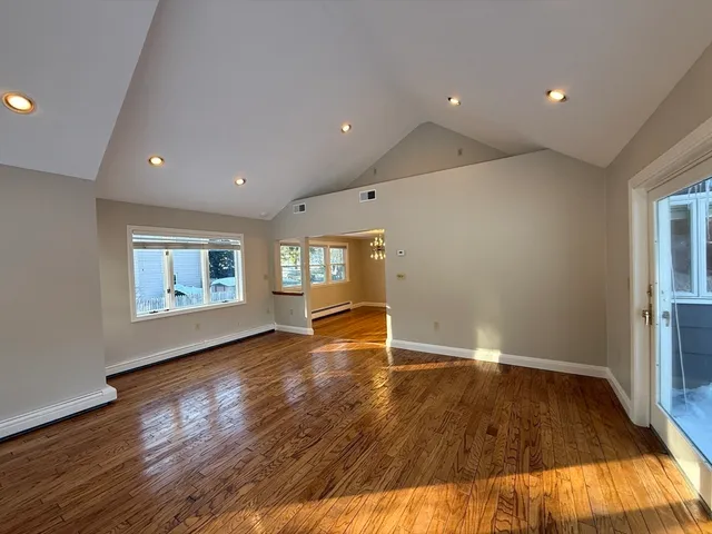 a view of empty room with wooden floor