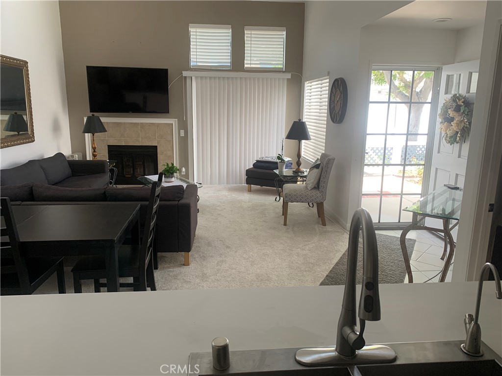 41 Fallingstar, Unit 28 Irvine, CA 92614 - Photo 13 of 34 a living room with furniture a flat screen tv and a fireplace