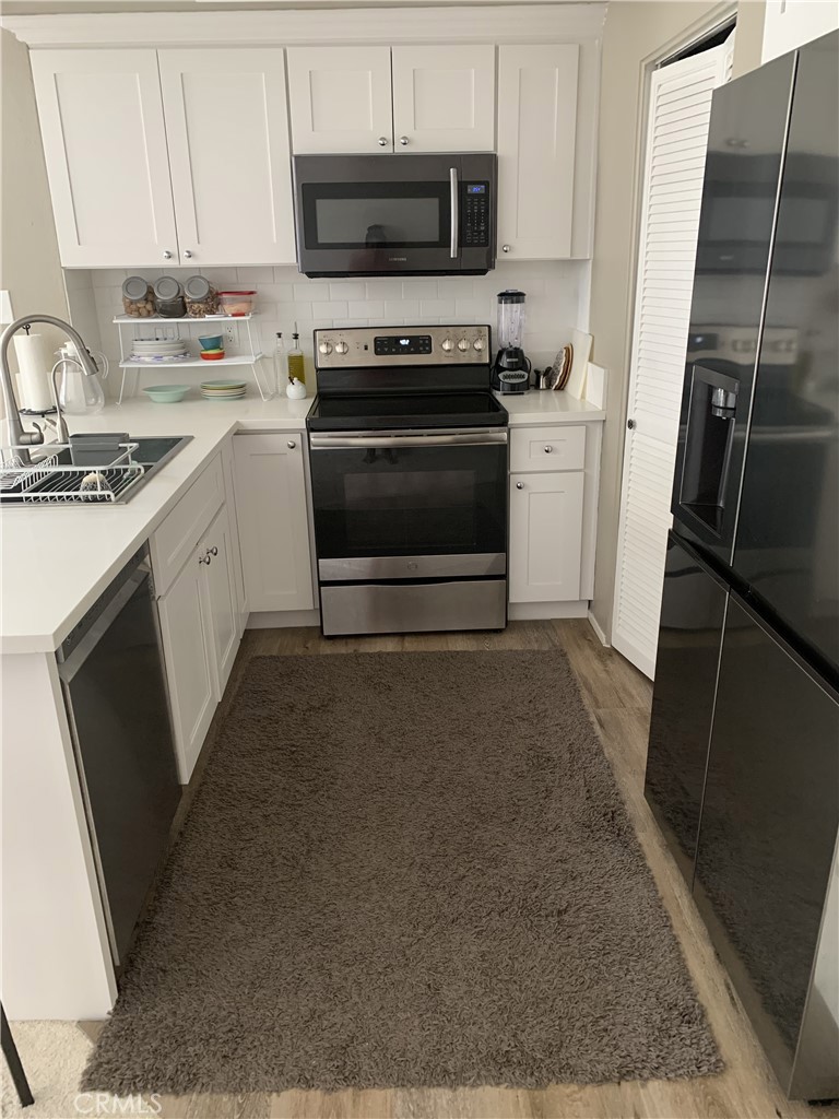41 Fallingstar, Unit 28 Irvine, CA 92614 - Photo 15 of 34 a kitchen with a sink appliances and cabinets