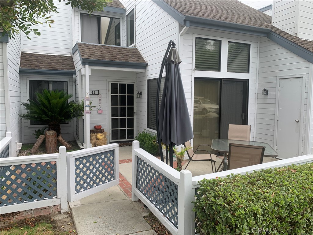 41 Fallingstar, Unit 28 Irvine, CA 92614 - Photo 3 of 34 a view of house with patio and wooden fence