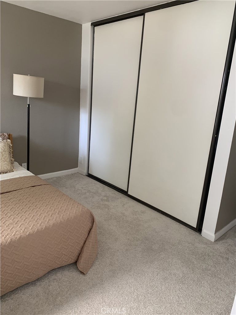 41 Fallingstar, Unit 28 Irvine, CA 92614 - Photo 10 of 34 a bedroom with a bed and a lamp