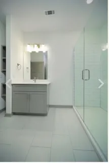 a bathroom with a double vanity sink mirror and bathtub
