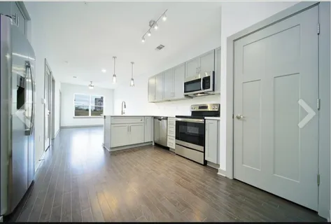 a kitchen with stainless steel appliances a stove top oven and refrigerator