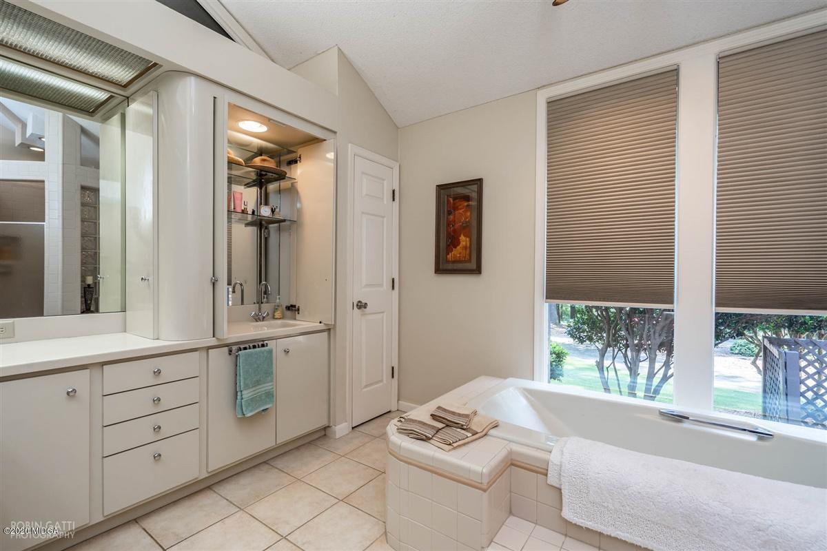 1225 Bass Road Macon, GA 31210 - Photo 28 of 58 a spacious bathroom with a double vanity sink a mirror a window and bathtub