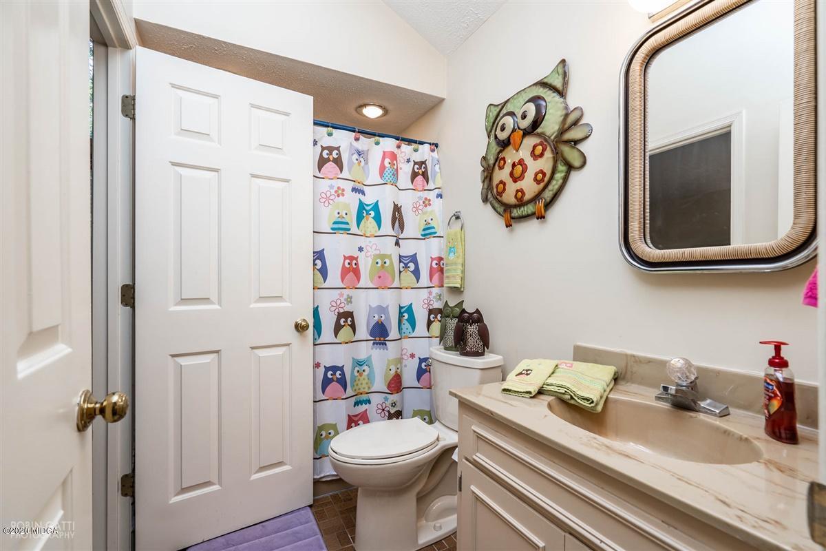 1225 Bass Road Macon, GA 31210 - Photo 31 of 58 a bathroom with a sink a toilet and a mirror