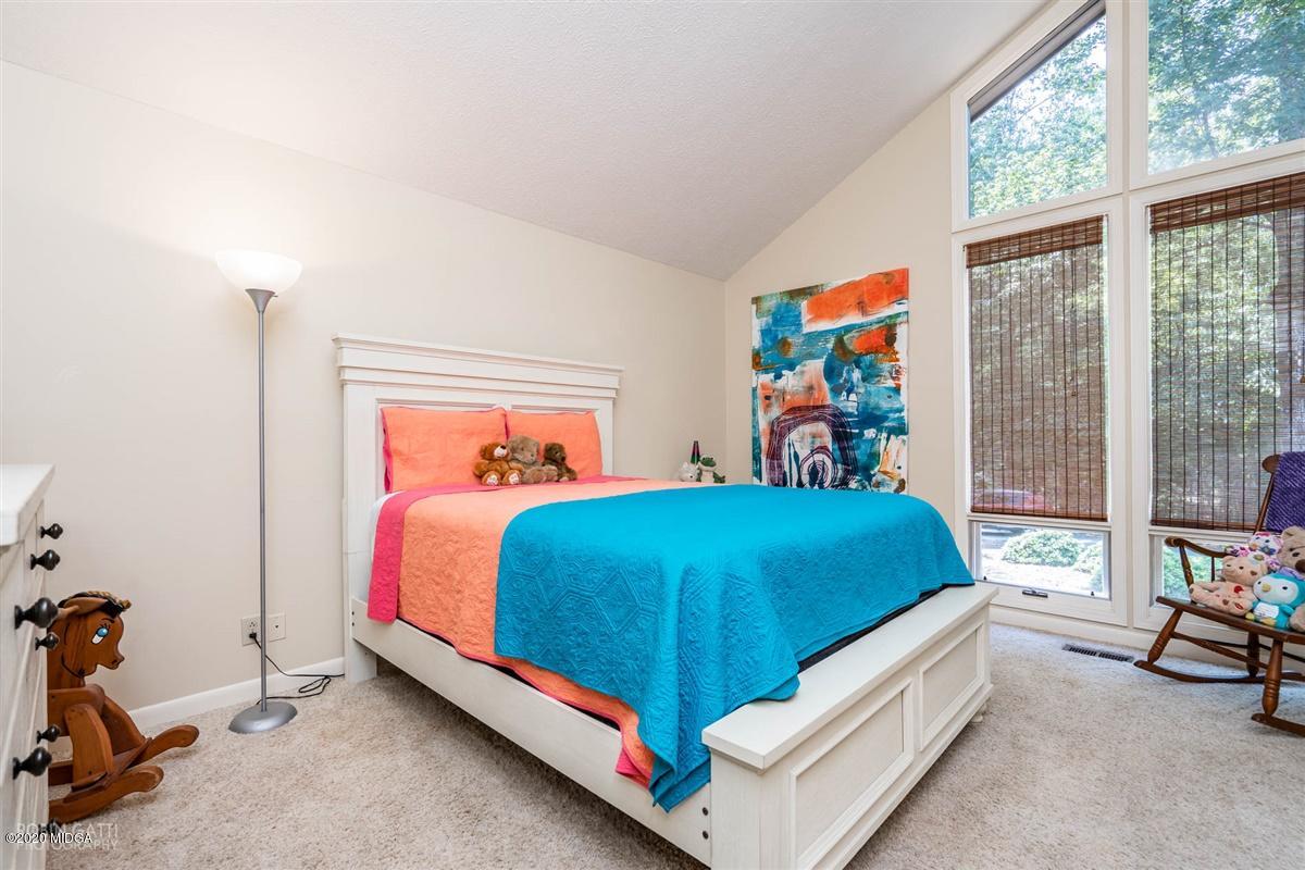 1225 Bass Road Macon, GA 31210 - Photo 32 of 58 a bed sitting in a bedroom next to a window