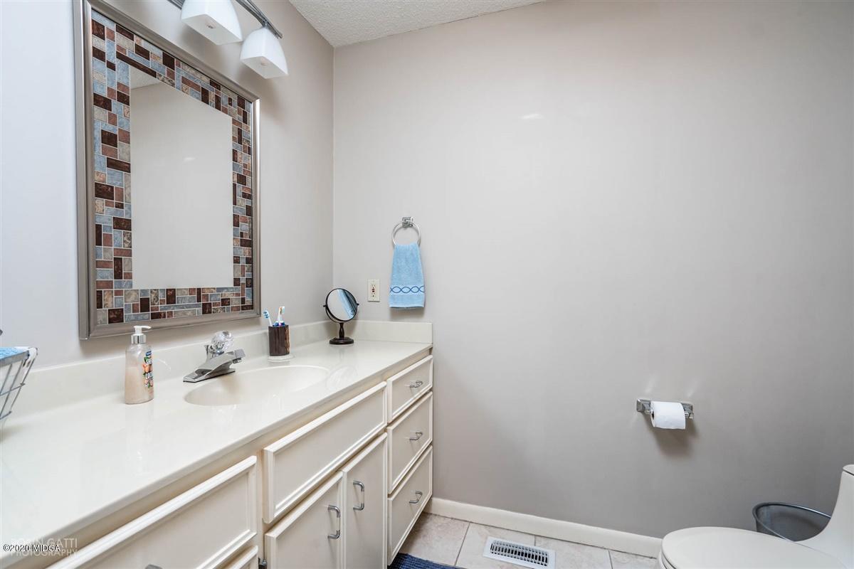 1225 Bass Road Macon, GA 31210 - Photo 37 of 58 a bathroom with a sink and a mirror