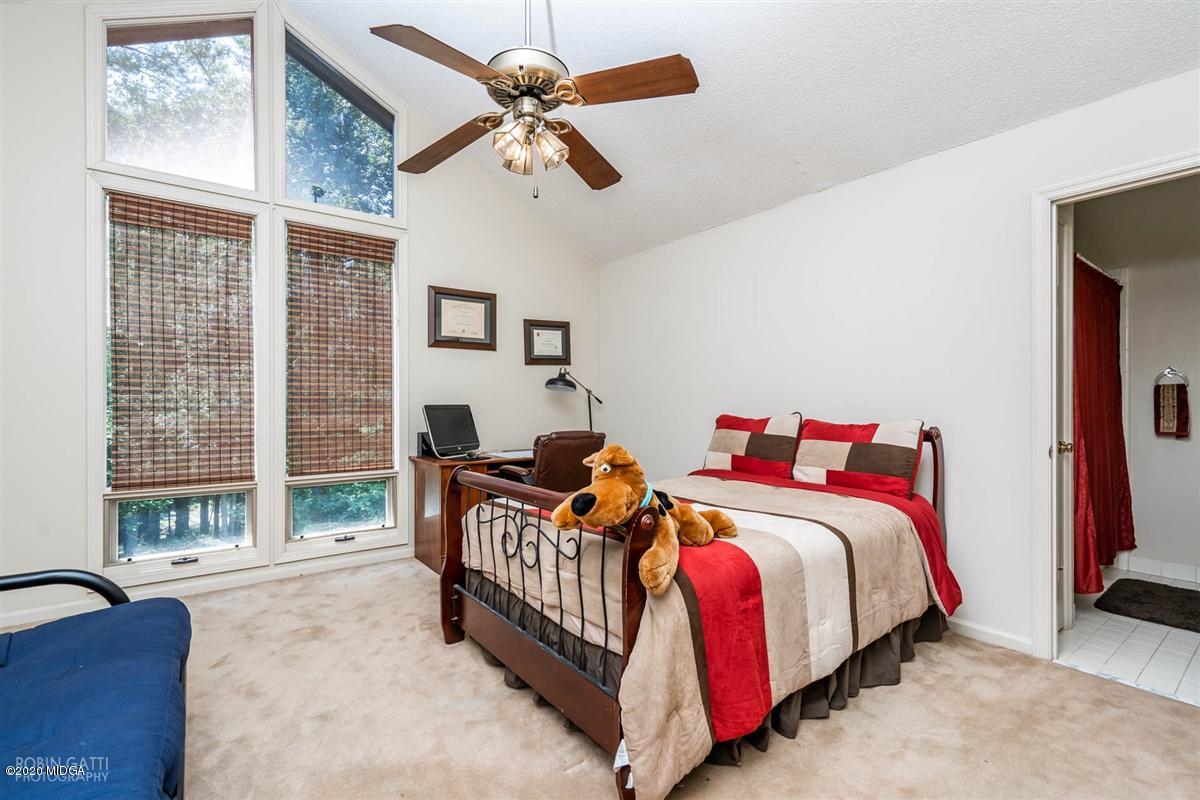 1225 Bass Road Macon, GA 31210 - Photo 41 of 58 a bedroom with a bed and a large window with the outer view