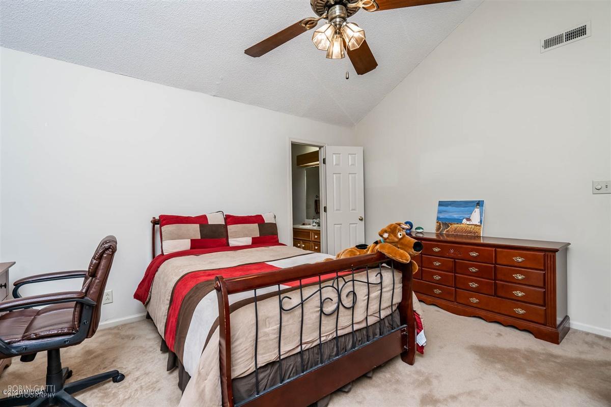 1225 Bass Road Macon, GA 31210 - Photo 42 of 58 a bedroom with a bed and a dresser