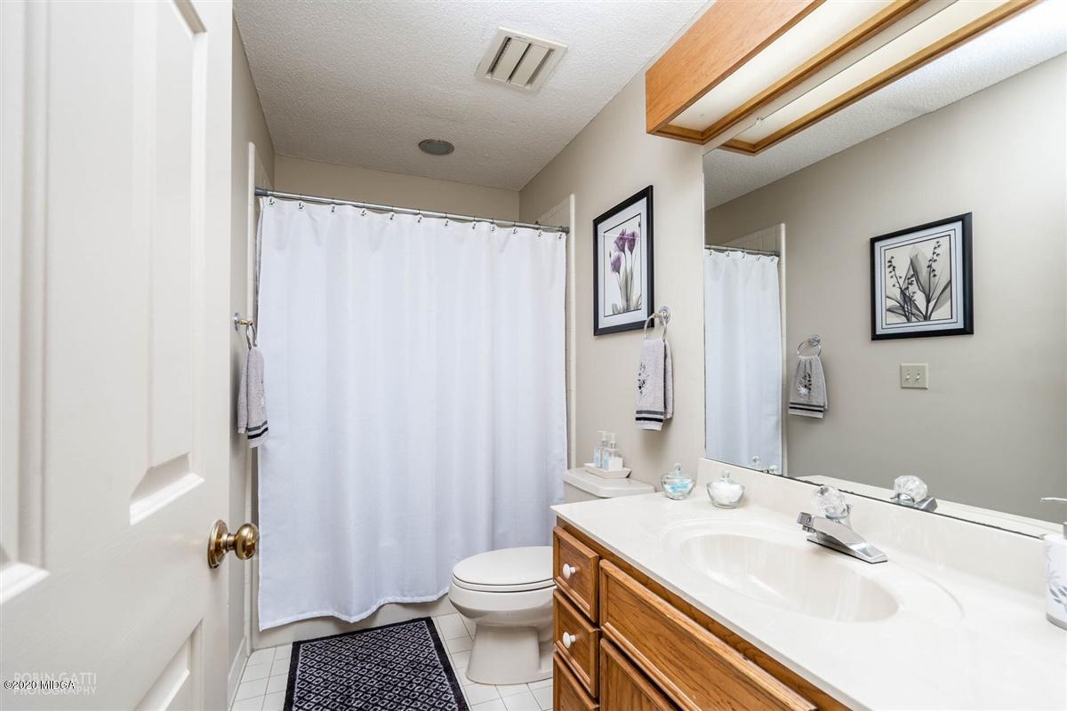 1225 Bass Road Macon, GA 31210 - Photo 44 of 58 a bathroom with a sink a toilet and shower curtain
