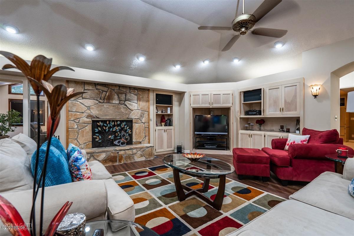 1225 Bass Road Macon, GA 31210 - Photo 6 of 58 a living room with furniture a flat screen tv and a fireplace