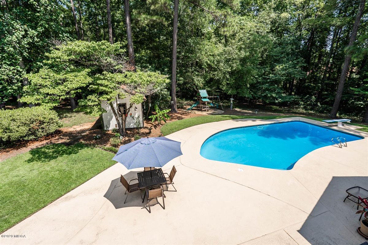 1225 Bass Road Macon, GA 31210 - Photo 54 of 58 a view of a swimming pool and lounge chairs