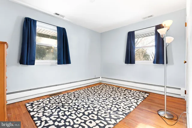 a view of a room with wooden floor and windows