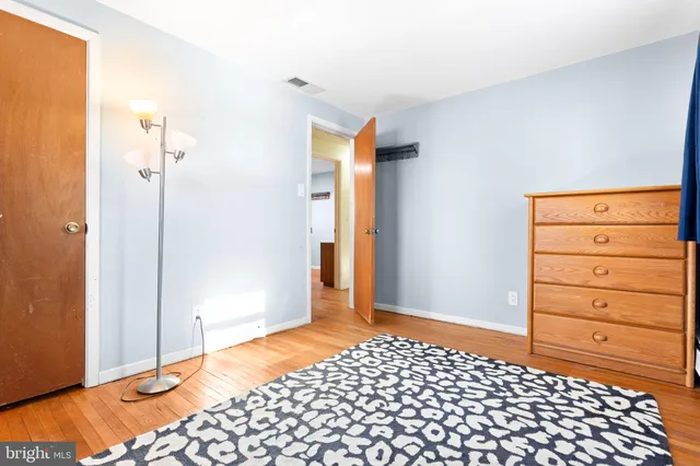 a bedroom with a dresser and a mirror