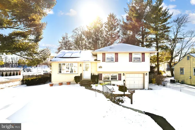 a view of a building with snow on the road