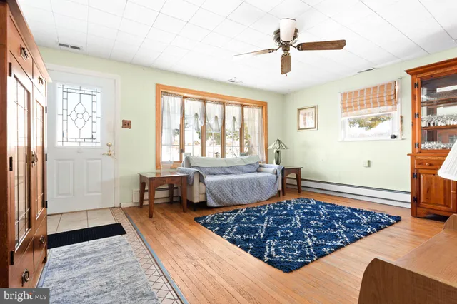 a bedroom with bed couch and window