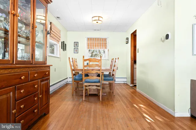 a dining room with furniture and wooden floor